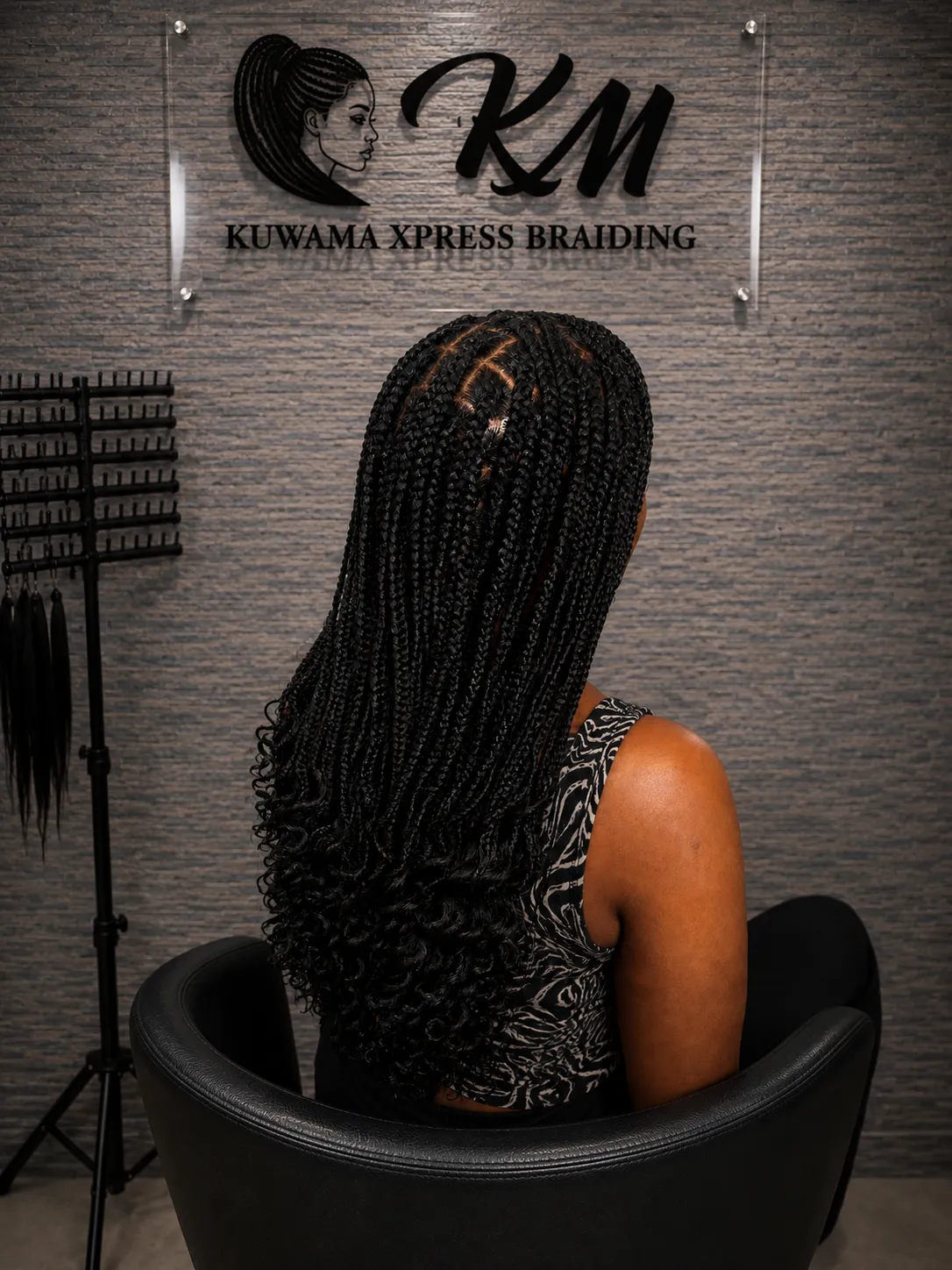Long knotless braids in a salon chair